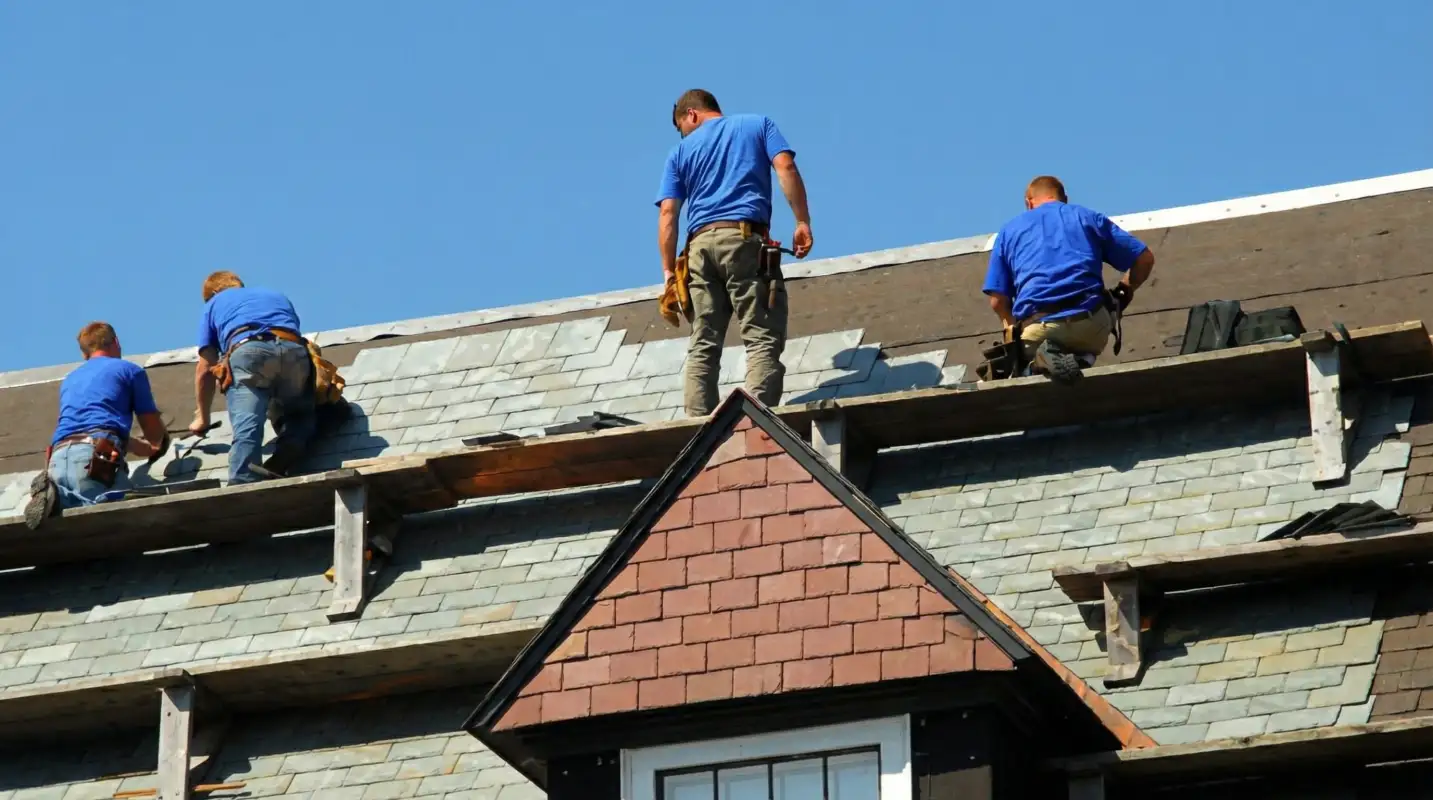 Roof replacement in progress with a team of professional contractors installing new shingles on a residential home in Atlanta, GA