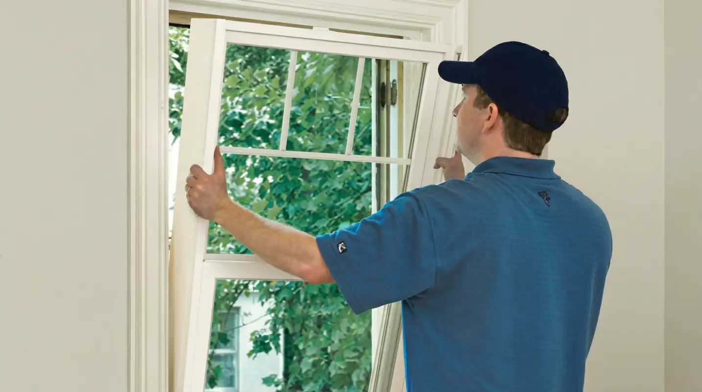 Professional contractors performing a residential window insulation and replacement service in Atlanta, GA